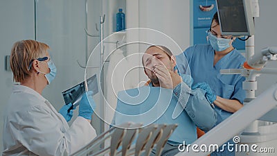 Patient complaining about toothache at stomatology consultation Stock Photo