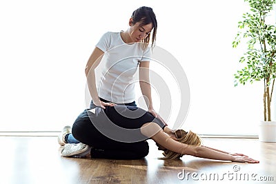 Patient doing physical exercises with his therapist in physio room. Stock Photo