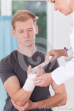 Patient having bandaged hand Stock Photo
