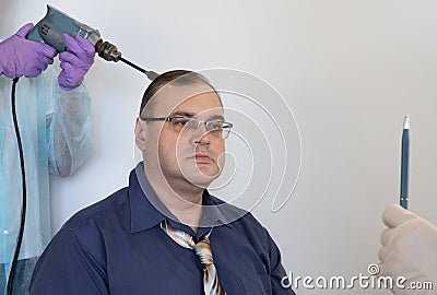 Patient in a hypnosis session. man is put into a trance by the actions of the hypnotist. concept of penetration into the human Stock Photo