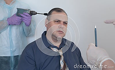 Patient in a hypnosis session. man is put into a trance by the actions of the hypnotist. concept of penetration into the human Stock Photo