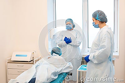 The patient lies on an operating table before an operation to remove moles on his back Stock Photo