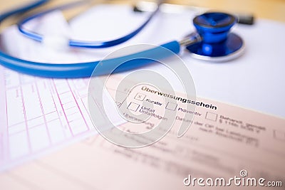patient's medical history, stethoscope, drug prescription, in German REFERRAL FORM CURATIVE for MRI, significance accurate Stock Photo