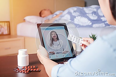 Patient`s relatives use video conference, make online consultation with doctor on mobile application, ask doctor about illness Stock Photo