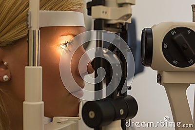 Patient at slit lamp of optician or optometrist Stock Photo