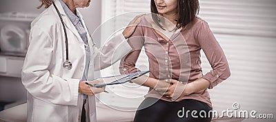 Patient suffering from stomach ache while consulting doctor Stock Photo