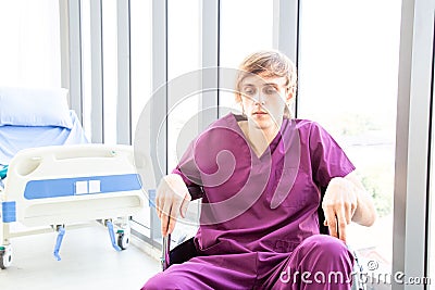 Patient was disheartened or hopeless, sitting on a wheelchair in the patient room Stock Photo