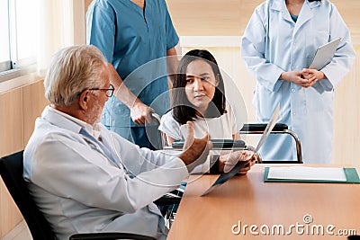 Patient in wheelchair discuss her health with doctor in sterile room. Stock Photo