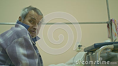 The patient is 72 years old. Extensive polyarthritis. Surgery hip fracture. Real Russian hospital die. A man will die Stock Photo
