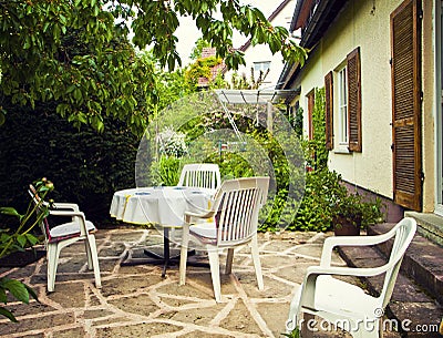 Patio with table and seats and garden view Stock Photo