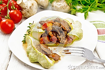Patisson stuffed with liver and mushrooms in plate on white board Stock Photo
