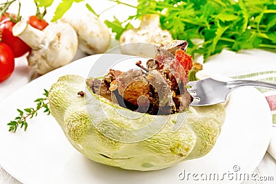 Patisson stuffed with liver and vegetables in plate on board Stock Photo