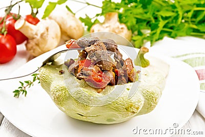Patisson stuffed with liver and vegetables in plate on white board Stock Photo