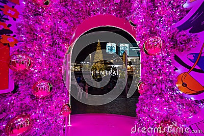 Hijabi cartoon carrying Merry Christmas and Happy New Year board inside a christmas tree Editorial Stock Photo