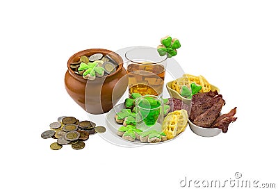 Patrick day coins clover meat snack stack of green liquor a glass of scotch whiskey with ice Stock Photo