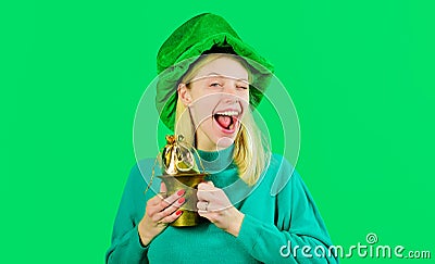 Patricks Day. Winking girl with pot of gold. Smiling woman in Leprechaun hat. Ireland traditions. Stock Photo