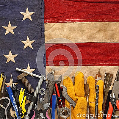 Patriotic collection of old and used work tools on worn US American flag. Made in USA, American workforce, or Labor Day Stock Photo