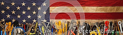 Patriotic collection of old and used work tools on worn US American flag. Made in USA, American workforce, or Labor Day Stock Photo