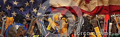 Patriotic collection of old and used work tools on worn US American flag. Made in USA, American workforce, or Labor Day Stock Photo