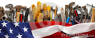 Patriotic collection of worn and used work tools with US American flag. Made in USA, American workforce, or Labor Day concept Stock Photo