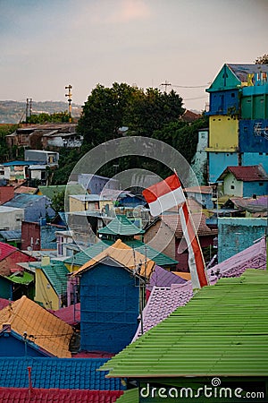 Patriotic Palette: Indonesian Flag Amidst Colorful Jodipan Stock Photo