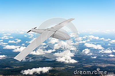 Patrolling unmanned aircraft in the sky above the terrain, fly tracking. Stock Photo