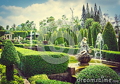 PATTAYA,THAILAND - March 18,2016: Sculpture of young girl of stone by the fountain in a tropical Park Nong Nooch in Thailand Editorial Stock Photo