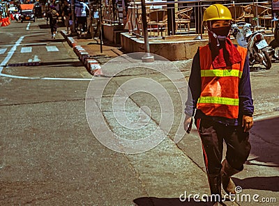 A female Thai worker was walking Editorial Stock Photo