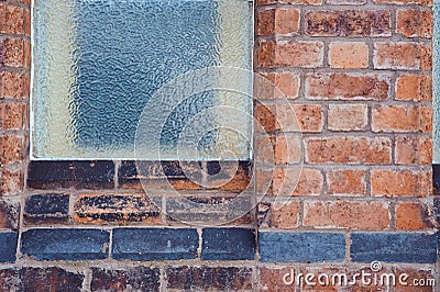 Pattern background image of frosted window on old redbrick wall with line of black bricks Stock Photo