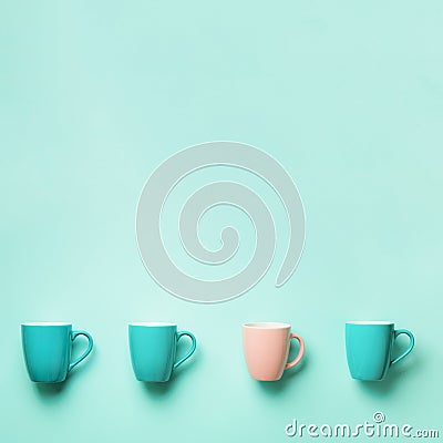 Pattern from blue and pink cups over turquoise background. Square crop. Birthday party celebration, baby shower concept Stock Photo