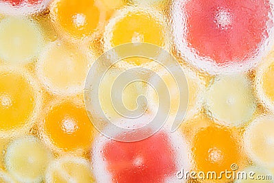 Pattern of different sliced citrus fruits on yellow background. Out of focus, water drops texture Stock Photo