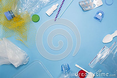 Pattern of many plastic bottles, caps, tubes, bags, tablets packaging arranged as a copy space frame on blue background. Saving th Stock Photo