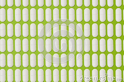 Pattern, many white pills on a green background Stock Photo