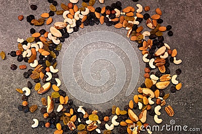 Pattern of nuts in circle form. Various nuts isolated on dark background. Pecan, brazil nut, walnut, almonds, hazelnuts, cashews. Stock Photo