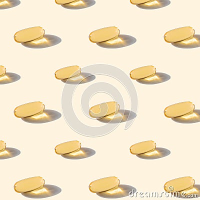 A pattern of omega capsules on a beige background. Stock Photo