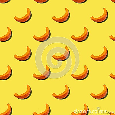 Pattern of pieces of pumpkin on a yellow background. Color of the year 2021 Illuminating. Vegetarian healthy food concept Stock Photo