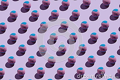 Pattern of pink and blue bath bombs on pastle purple Stock Photo