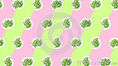 Pattern of plates with lightly fried brussels sprouts on the neon green and pink color drop Stock Photo