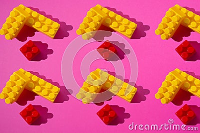 Pattern of red and yellow constructor details on a pink background Stock Photo