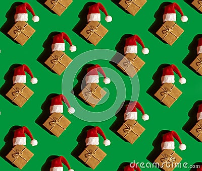 Pattern of Santa hat on paper gift box present on green background. Copy space for your text. Mock up for advertisement Stock Photo