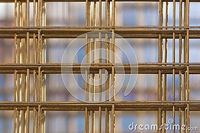 Pattern from stack of rebar grids on blue background Stock Photo