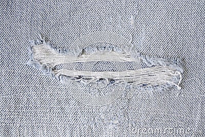 Pattern of tear and old on denim trousers, detail jeans texture for background Stock Photo