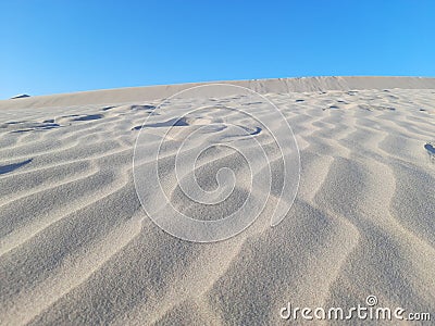 Pattern waves with footprints in sand dunes Stock Photo