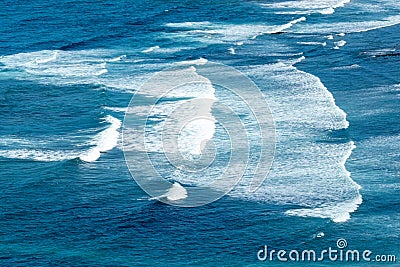 pattern of waves with spume at the beach Stock Photo