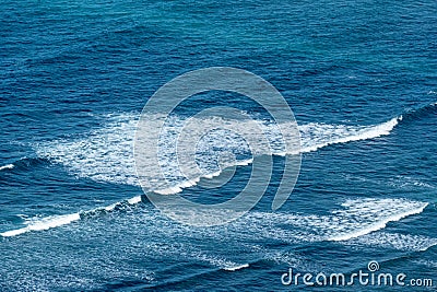 pattern of waves with spume at the beach Stock Photo