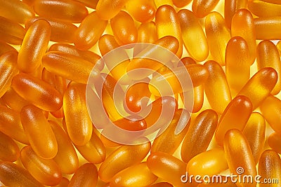pattern with yellow gelatin capsules for background. omega viramins close-up macro Stock Photo