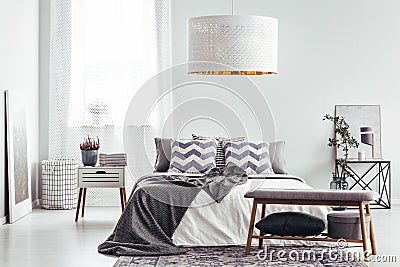 Patterned cushions in bright bedroom Stock Photo