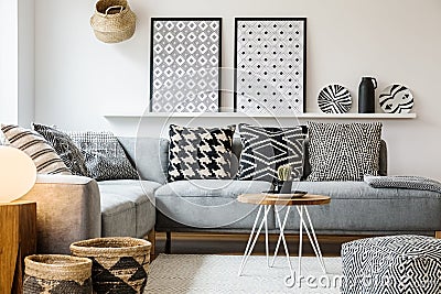 Patterned pillows on grey corner sofa in apartment Stock Photo