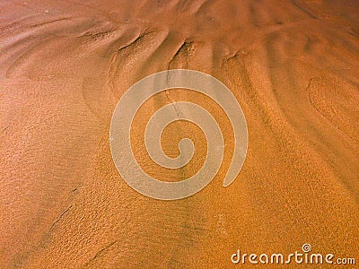 Patterns from the waves and wind on the sand, sand of an unusual color Stock Photo