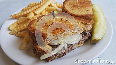 Patty melt with french fries and a dill pickle Stock Photo